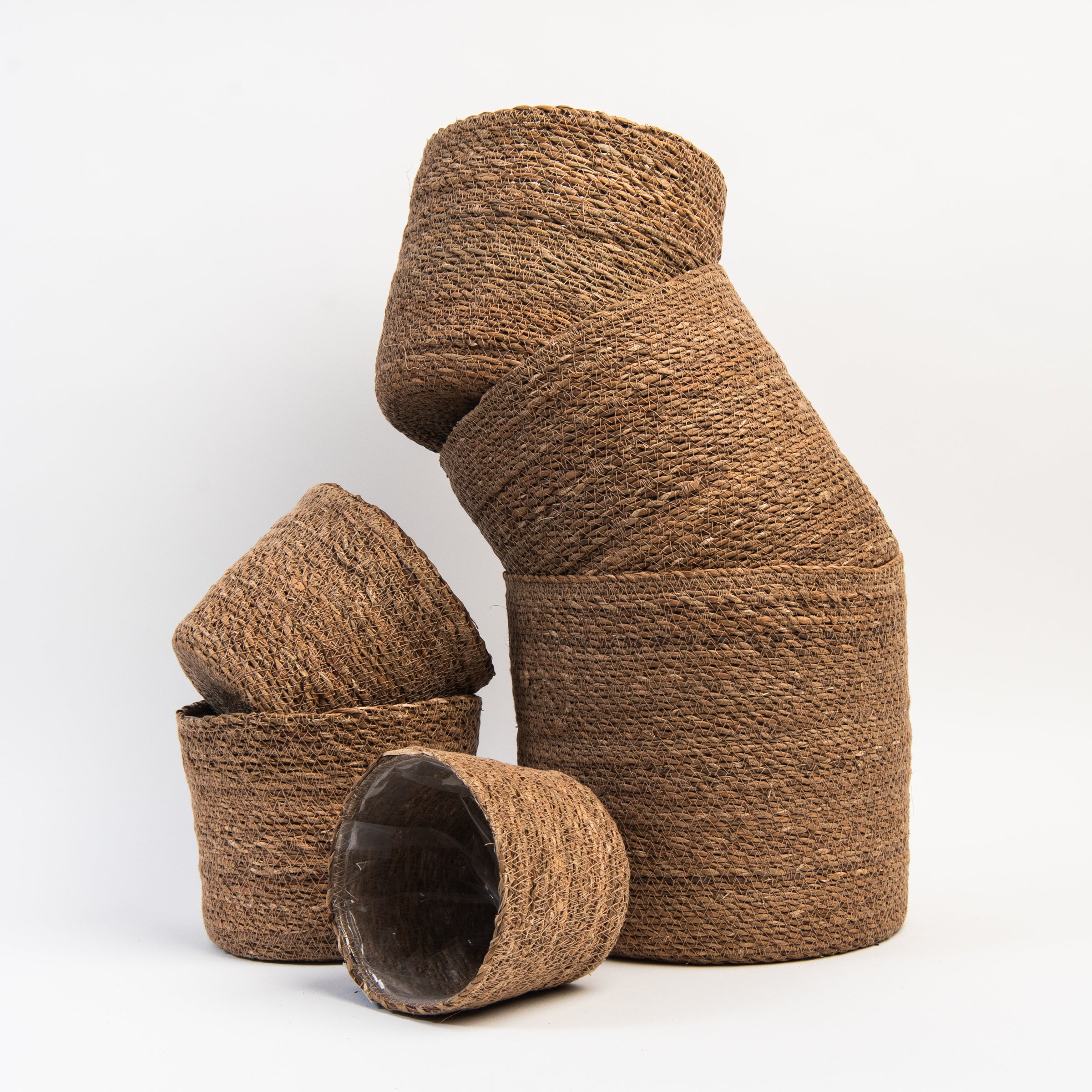 Hand-Woven Baskets with Plastic Lining on a white background at Addison West