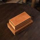 Large and small Allerona Leather Box with Brass Trim on a wood table at Addison West