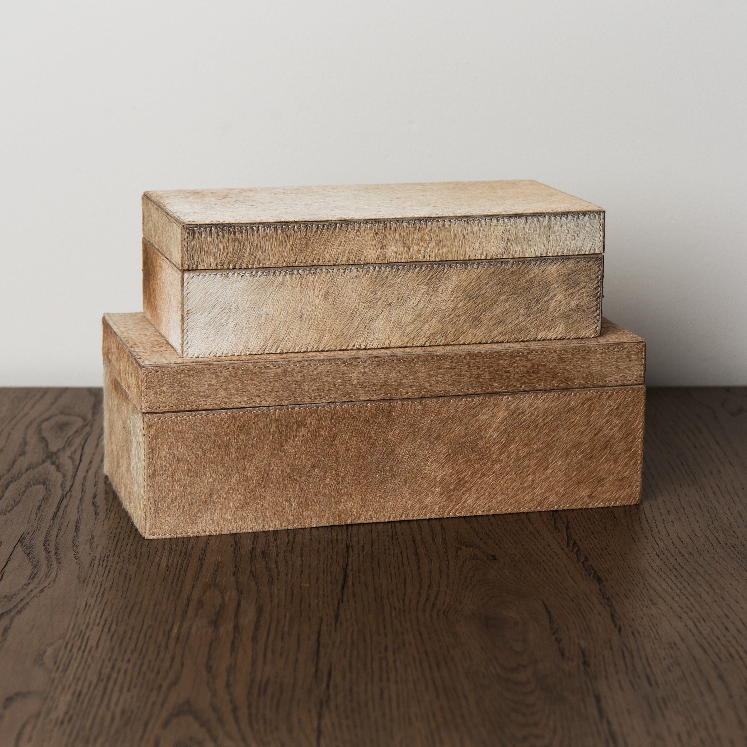 Medium and small Harrington Hide Box on a wood table at Addison West