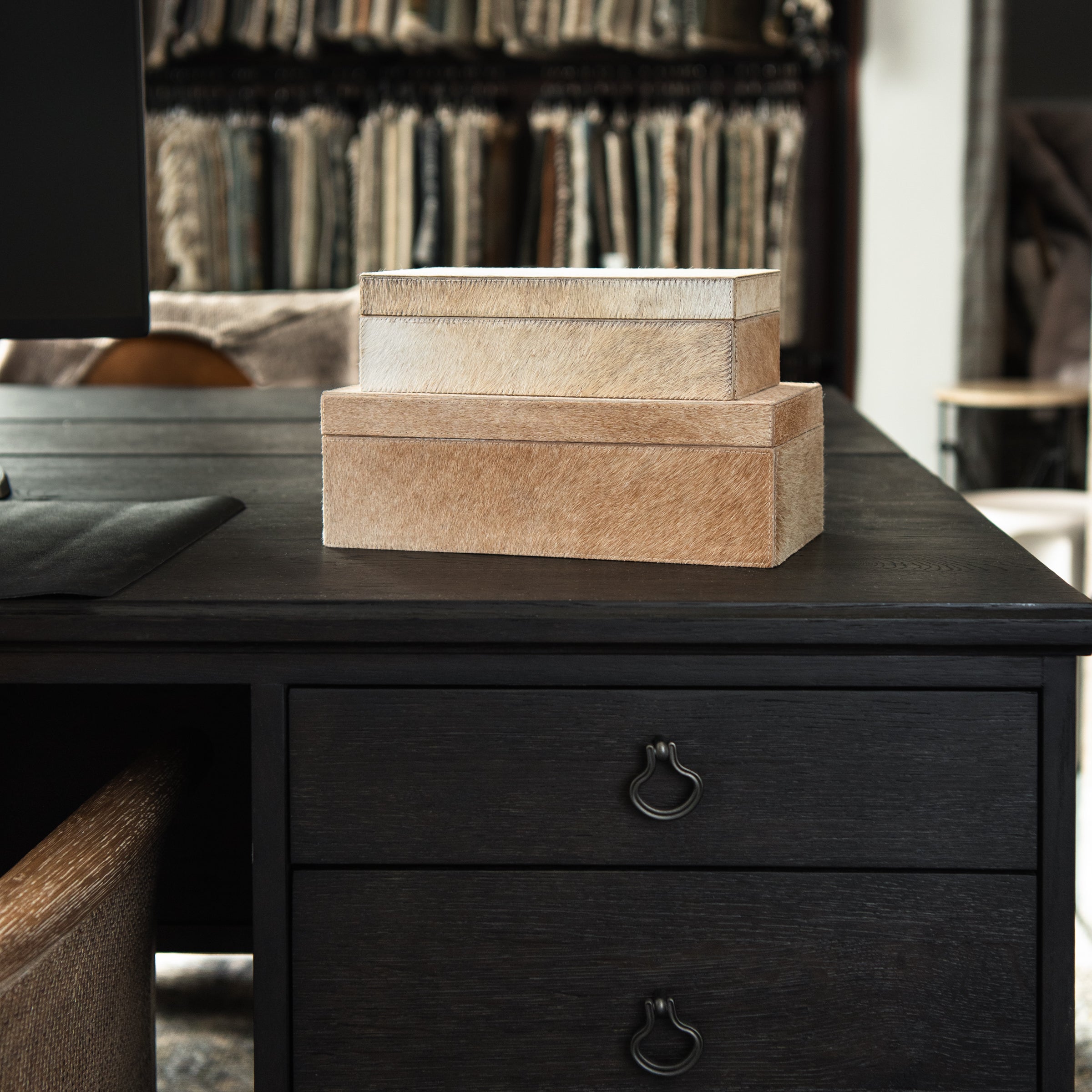 Medium and small Harrington Hide Box on a black desk at Addison West