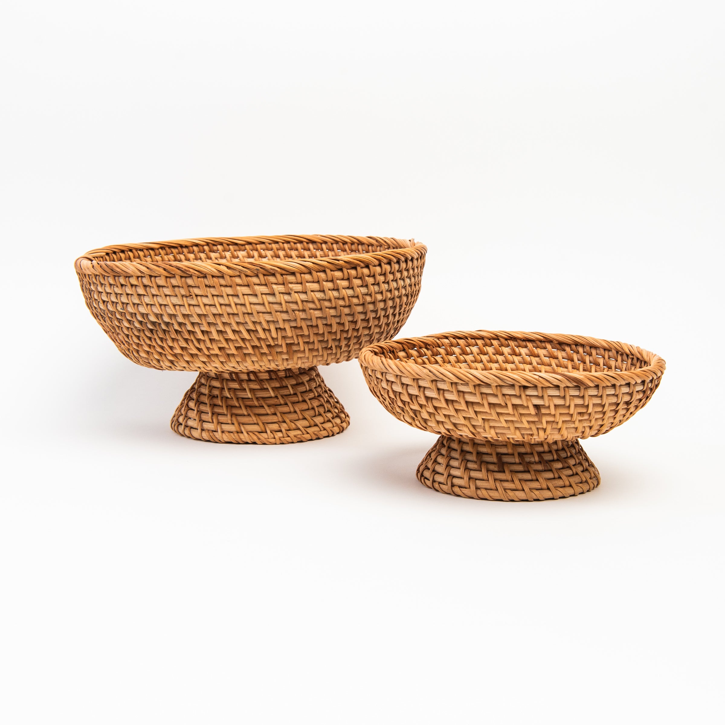 Small and large Rattan Footed Bowl on white background at Addison West
