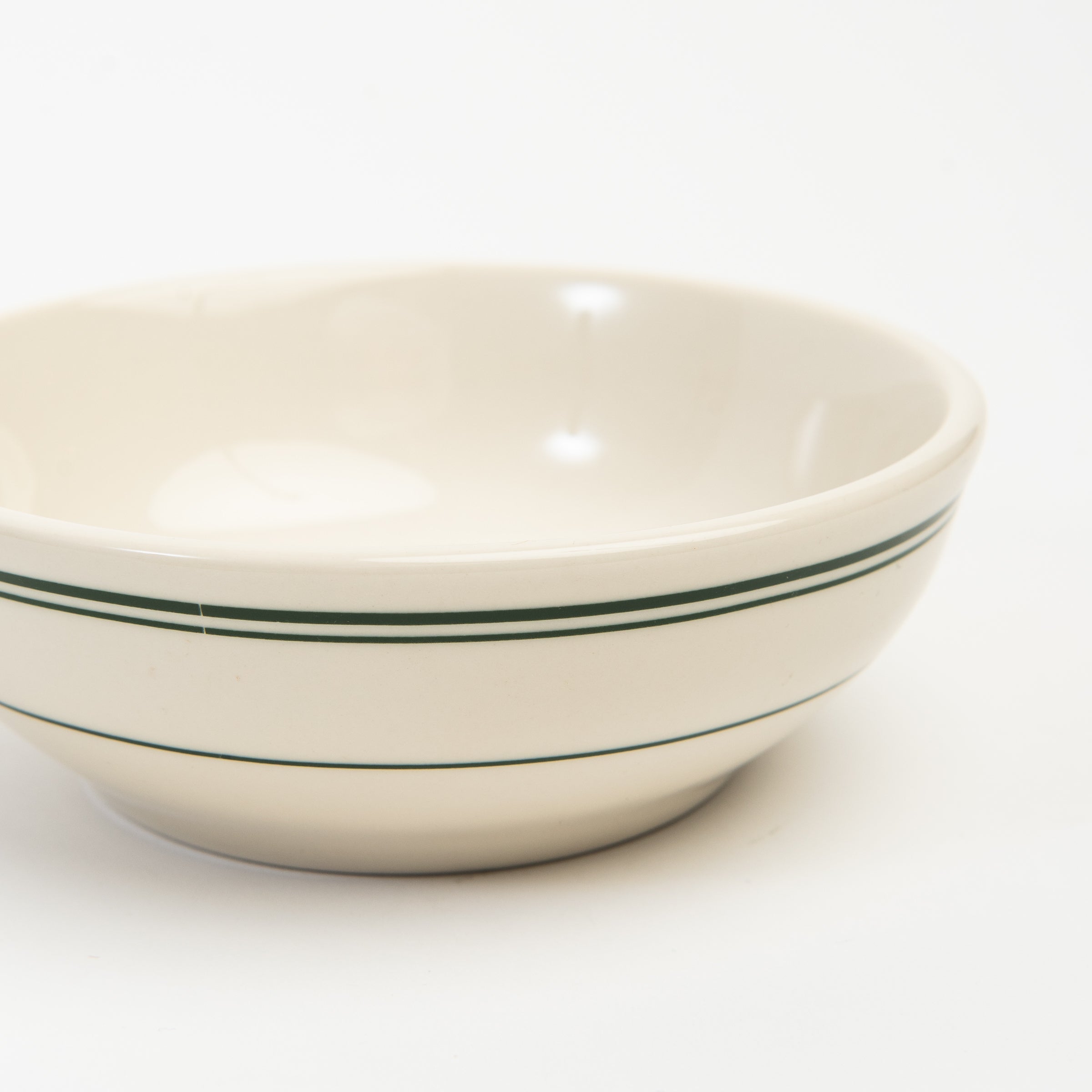 Close up of Fish's Eddy Greenband Cereal Bowl on a white background at Addison West