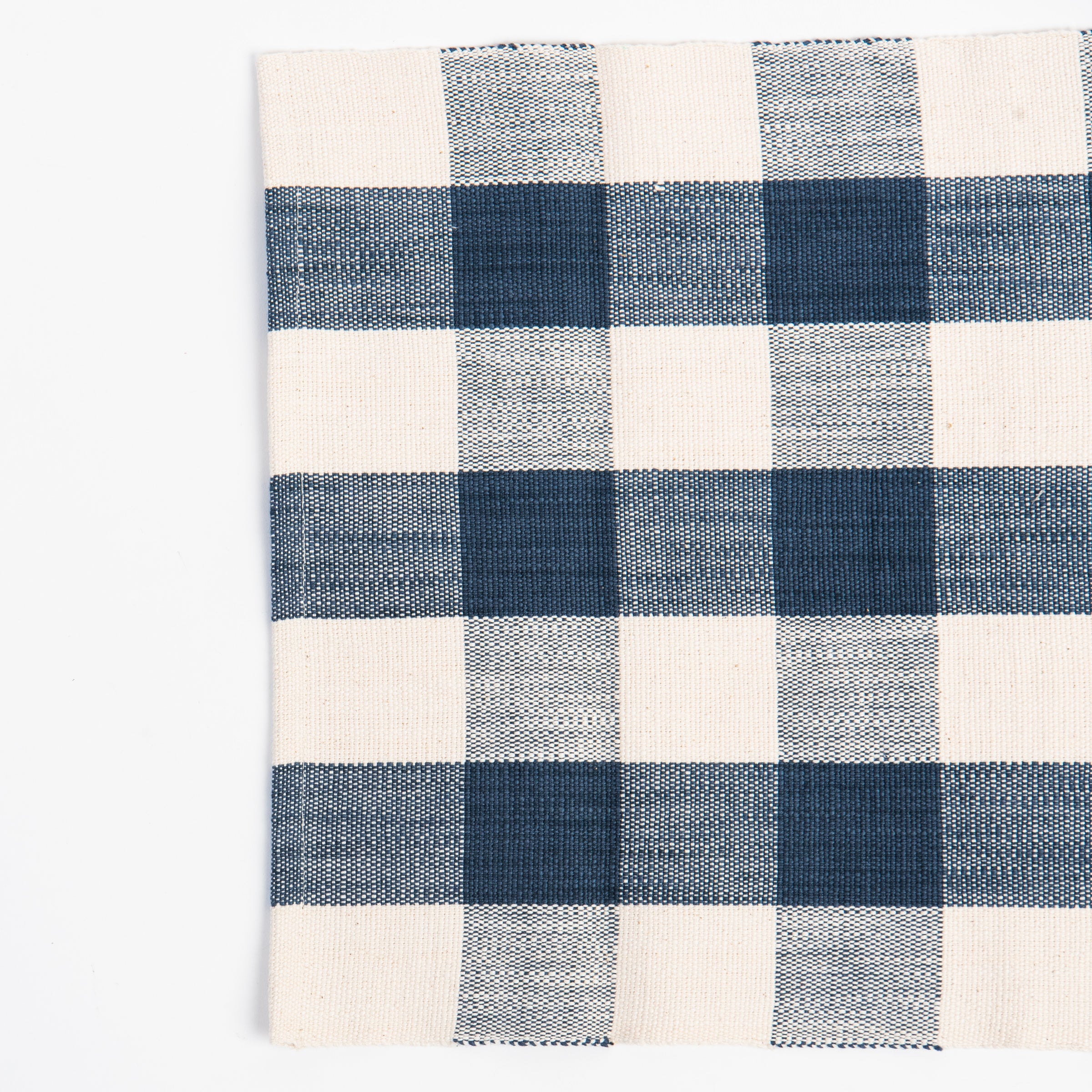 Closeup of Grace Gingham Table Runner in Dark Blue on a white background at Addison West