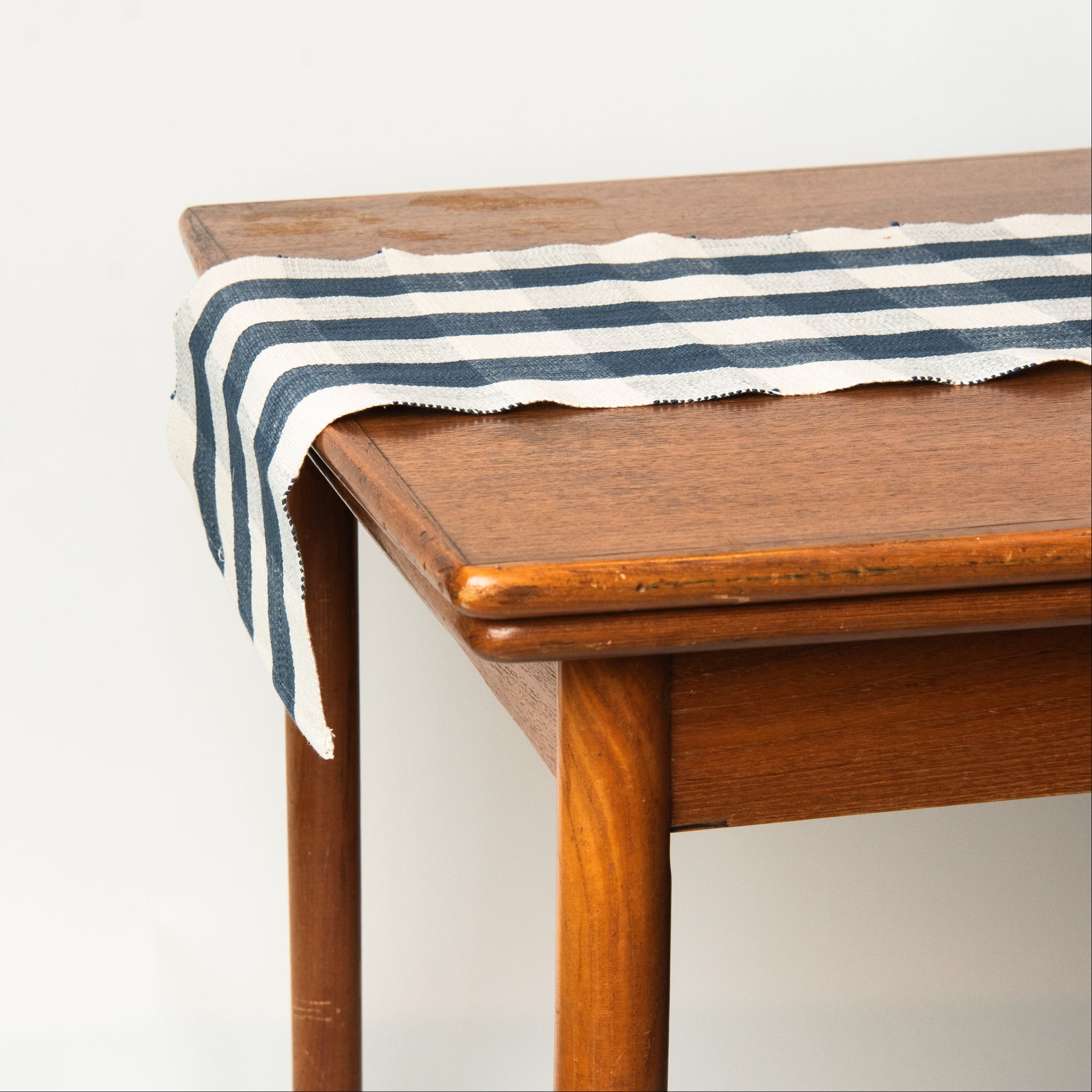 Grace Gingham Table Runner in Dark Blue on a table at Addison West