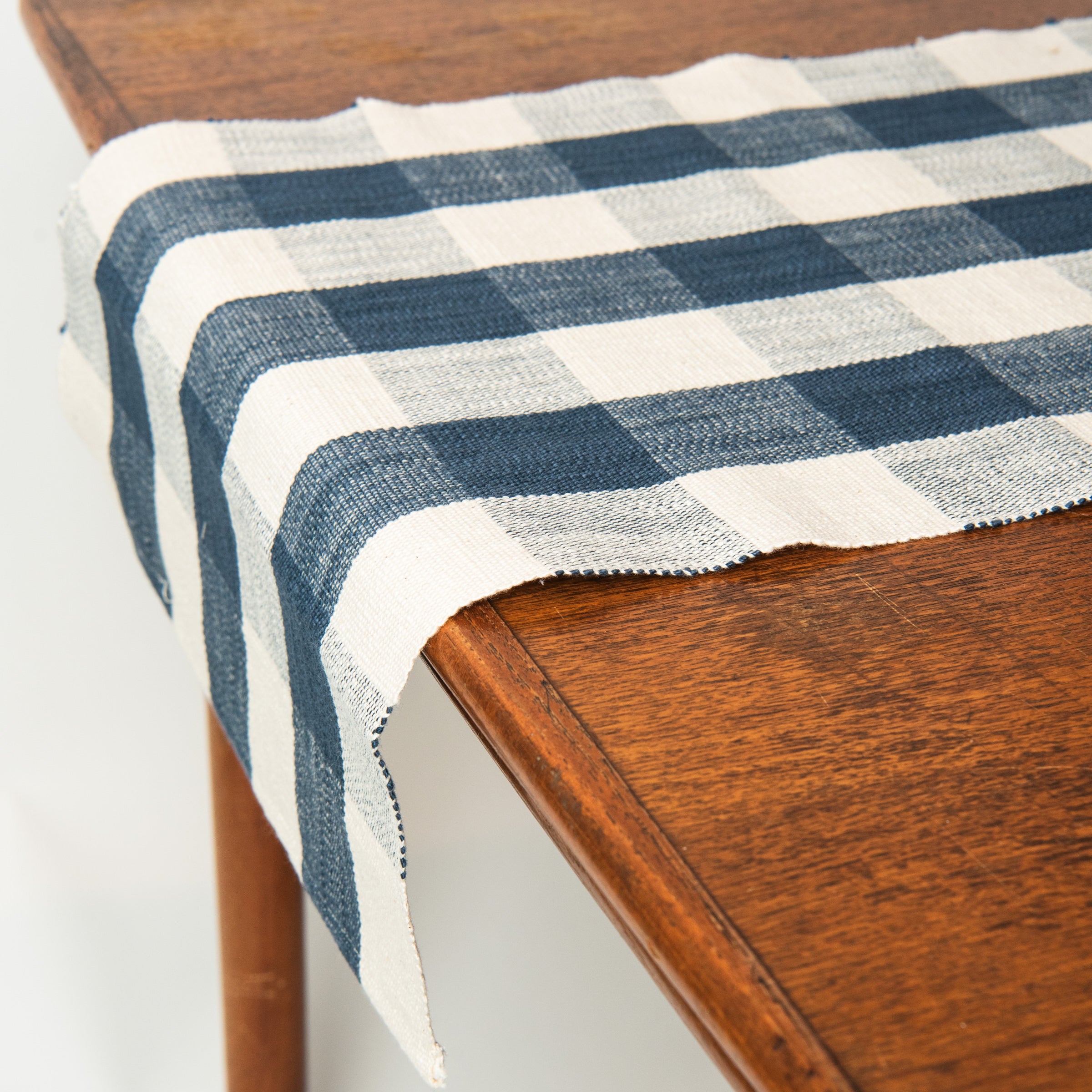 Grace Gingham Table Runner in Dark Blue on a table at Addison West