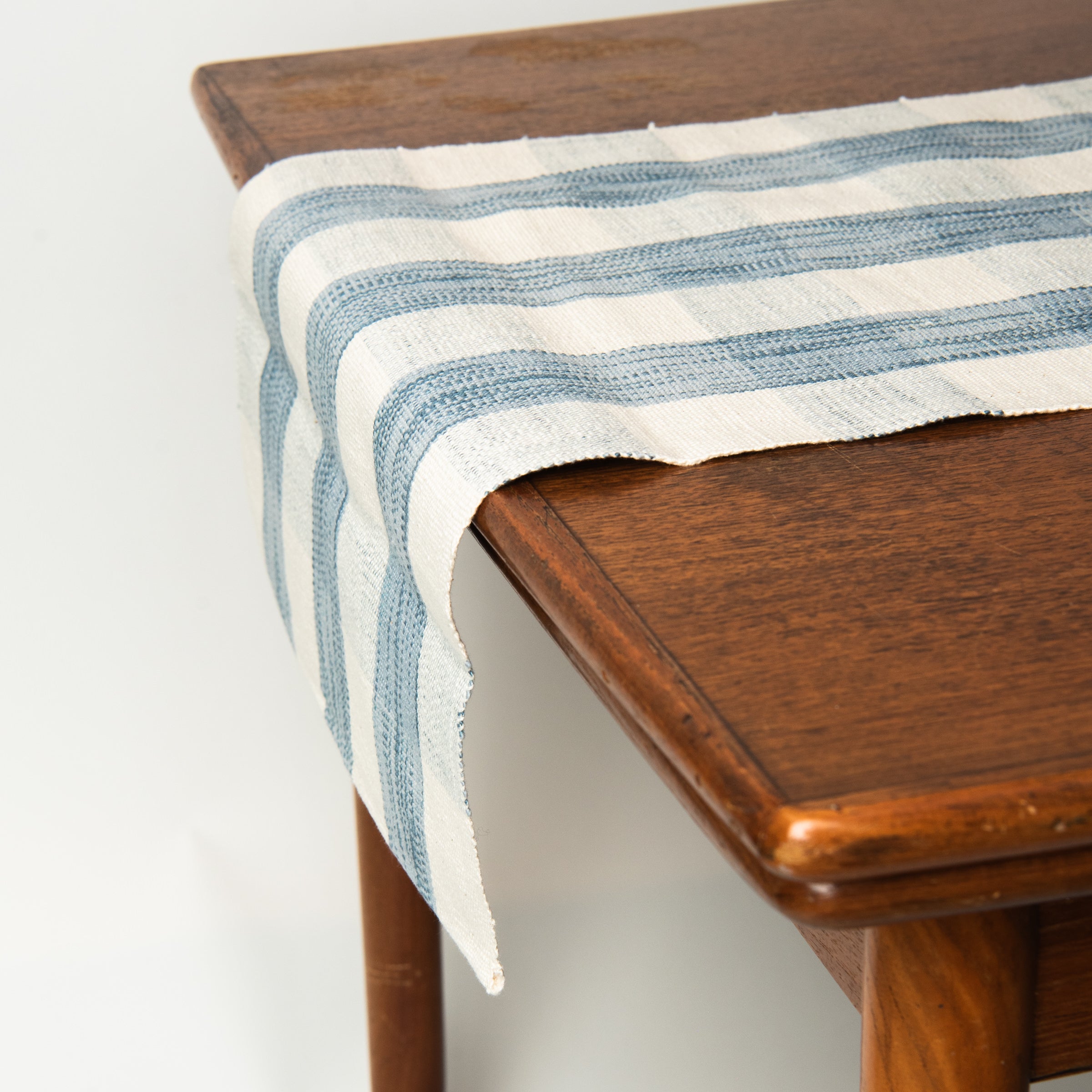 Grace Gingham Table Runner in Light Blue on a table at Addison West