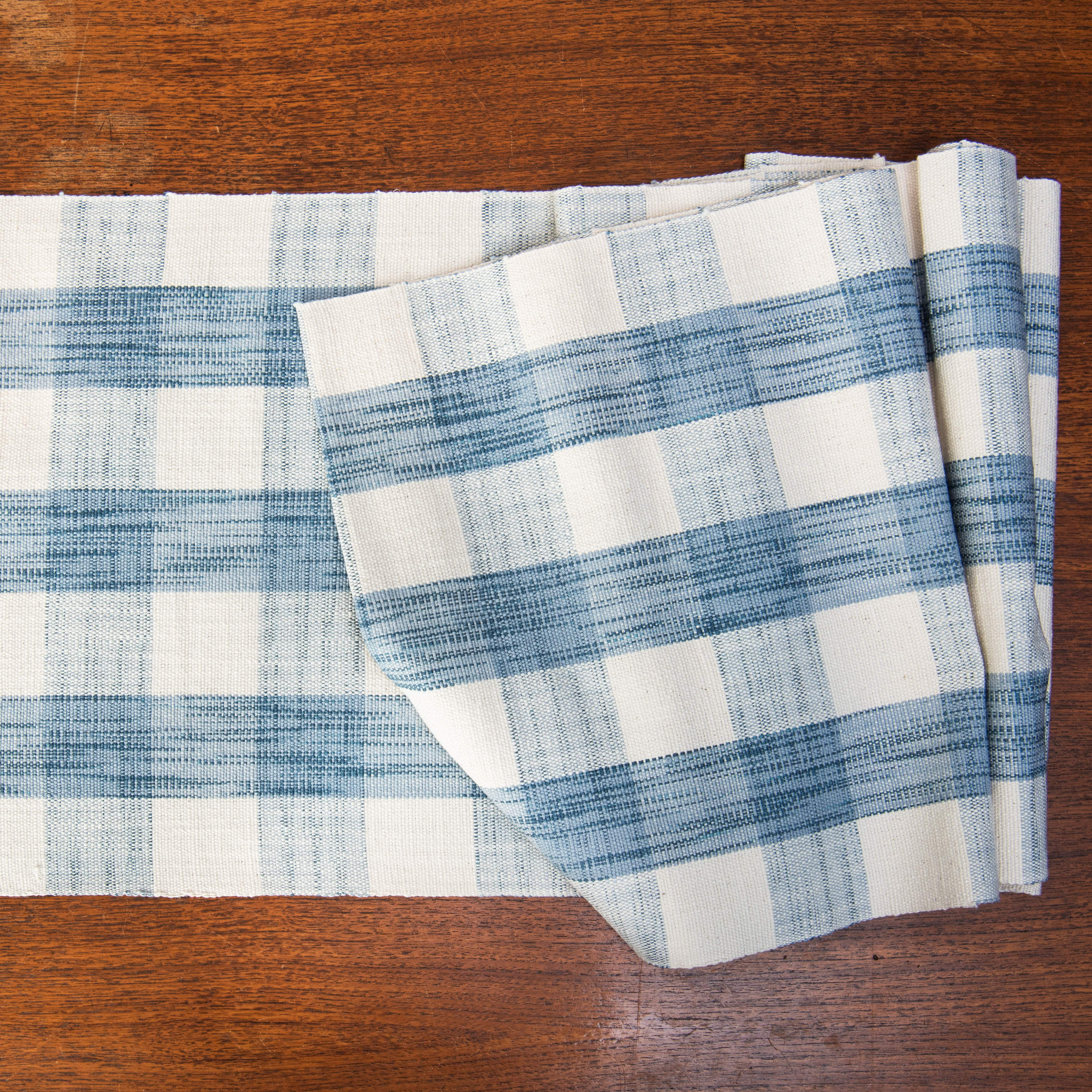 Grace Gingham Table Runner in Light Blue on a table at Addison West