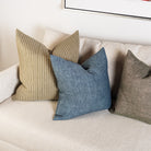 20" Linen Chambray Pillow in Denim and green on a sofa at Addison West