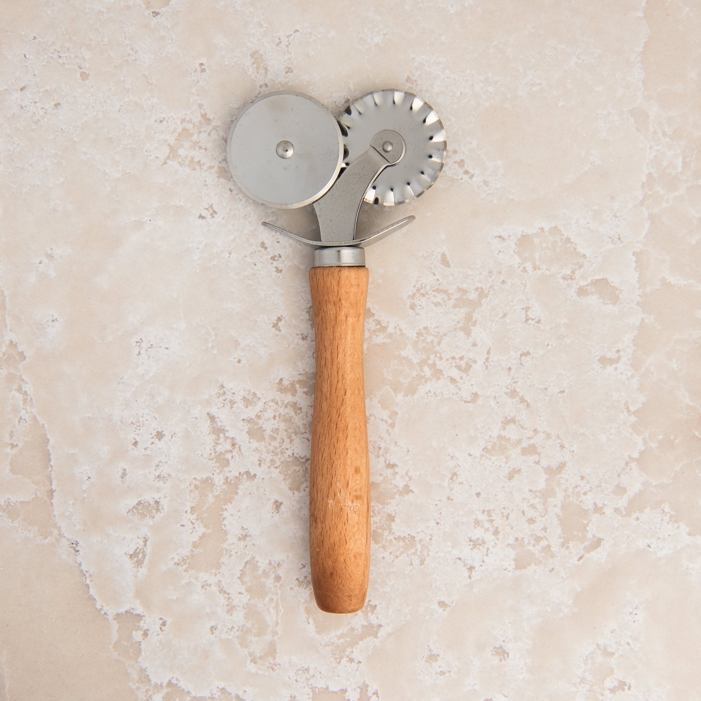 Pastry Cutter & Crimper on a beige background at Addison West