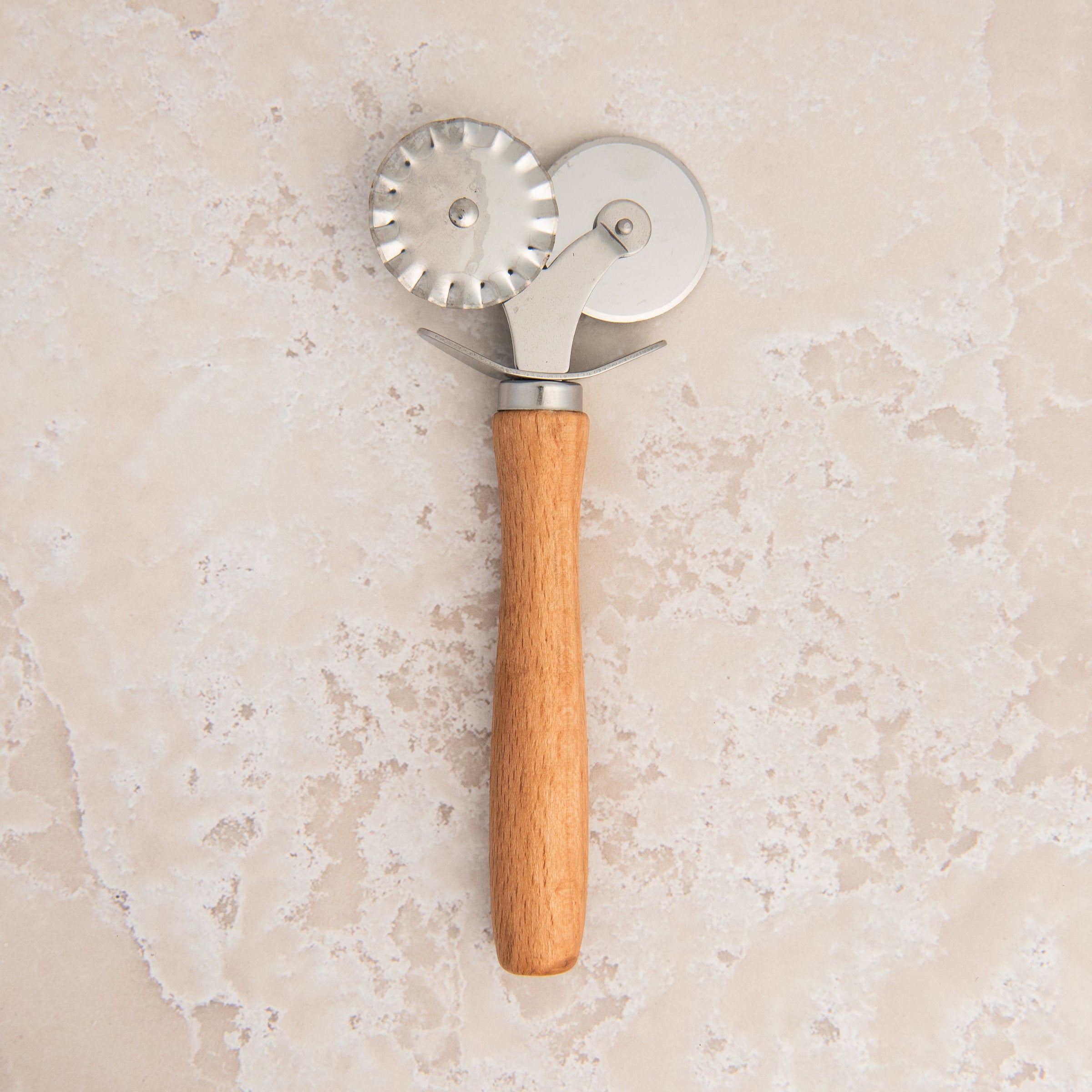 Pastry Cutter & Crimper on a beige background at Addison West