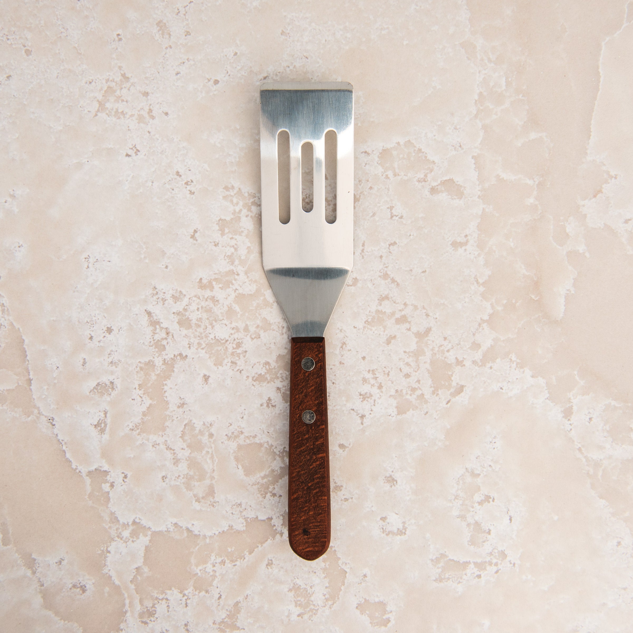 Brownie Spatula on a beige background at Addison West