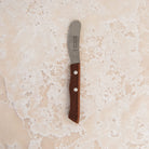 La Fourmi Butter Knife on a beige background at Addison West