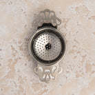 English Tea Strainer on a beige background at Addison West