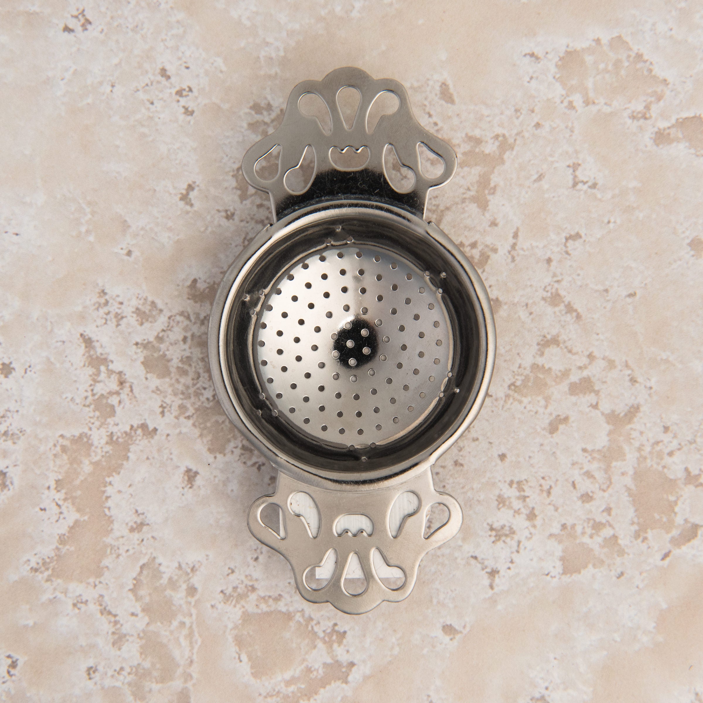 English Tea Strainer on a beige background at Addison West