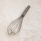 9.5 Inch Ballon Whisk on a beige background at Addison West