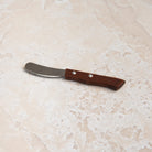 La Fourmi Butter Knife on a beige background at Addison West