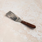 Brownie Spatula on a beige background at Addison West