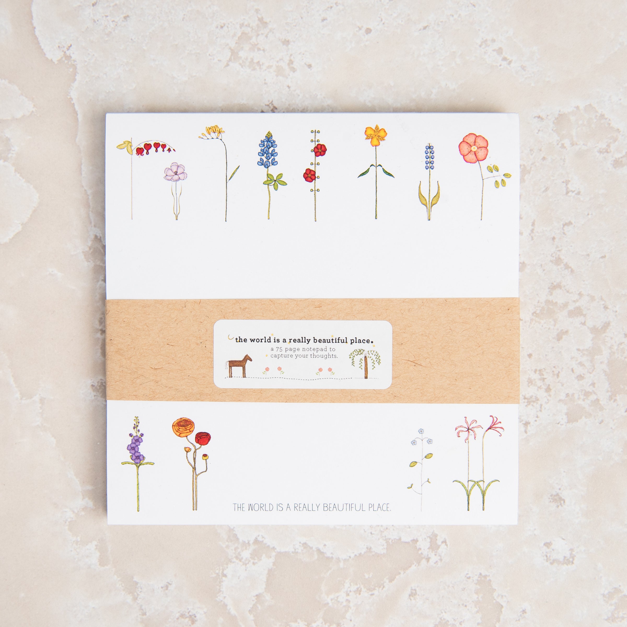 Mini Silicone Spoon Spatula in Blue on a beige background at Addison West