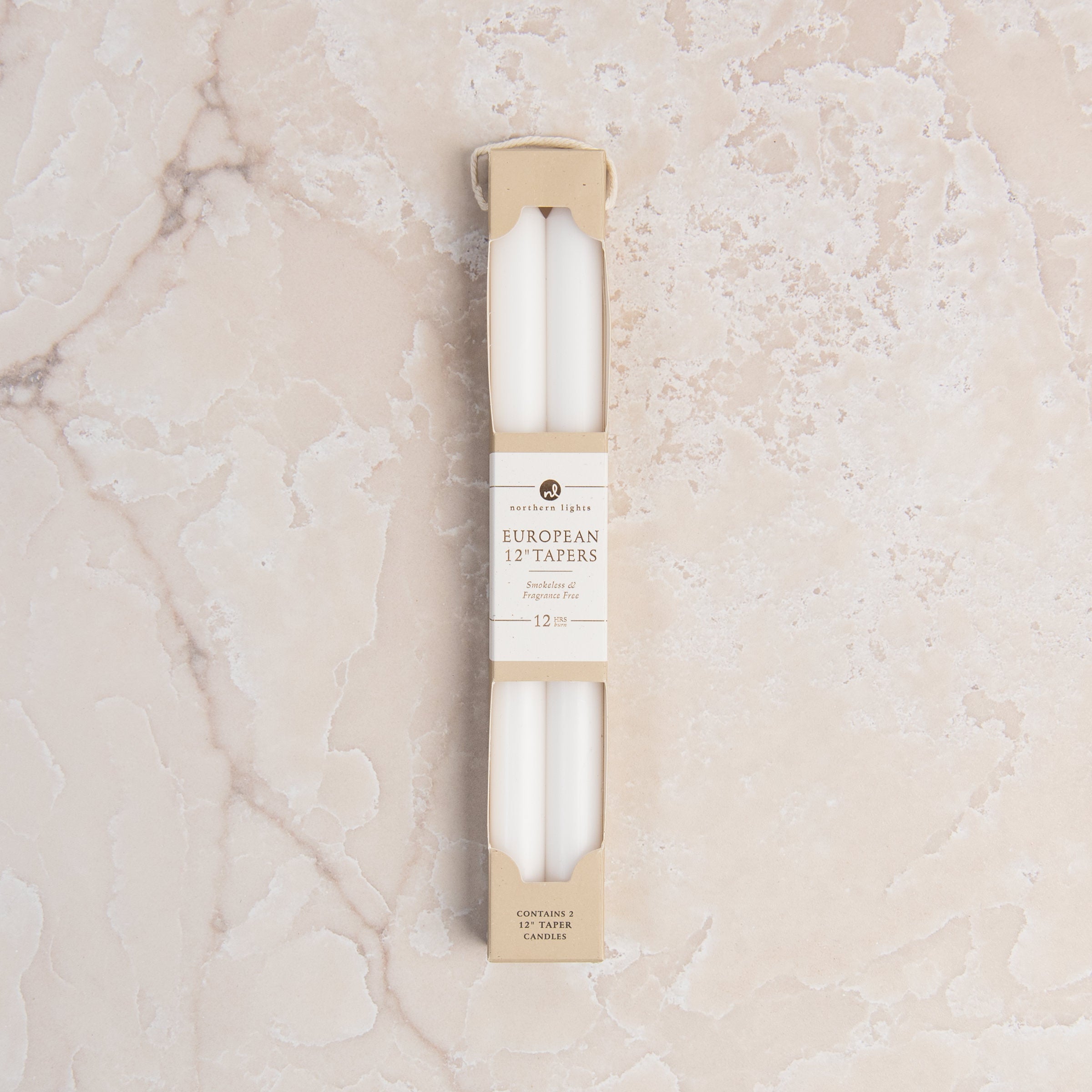 12" Taper Candles in Pure White in Set of 2 on a table at Addison West