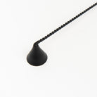 Black metal Candle Snuffer on a white background at Addison West