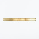 Brass ruler on a white background at Addison West
