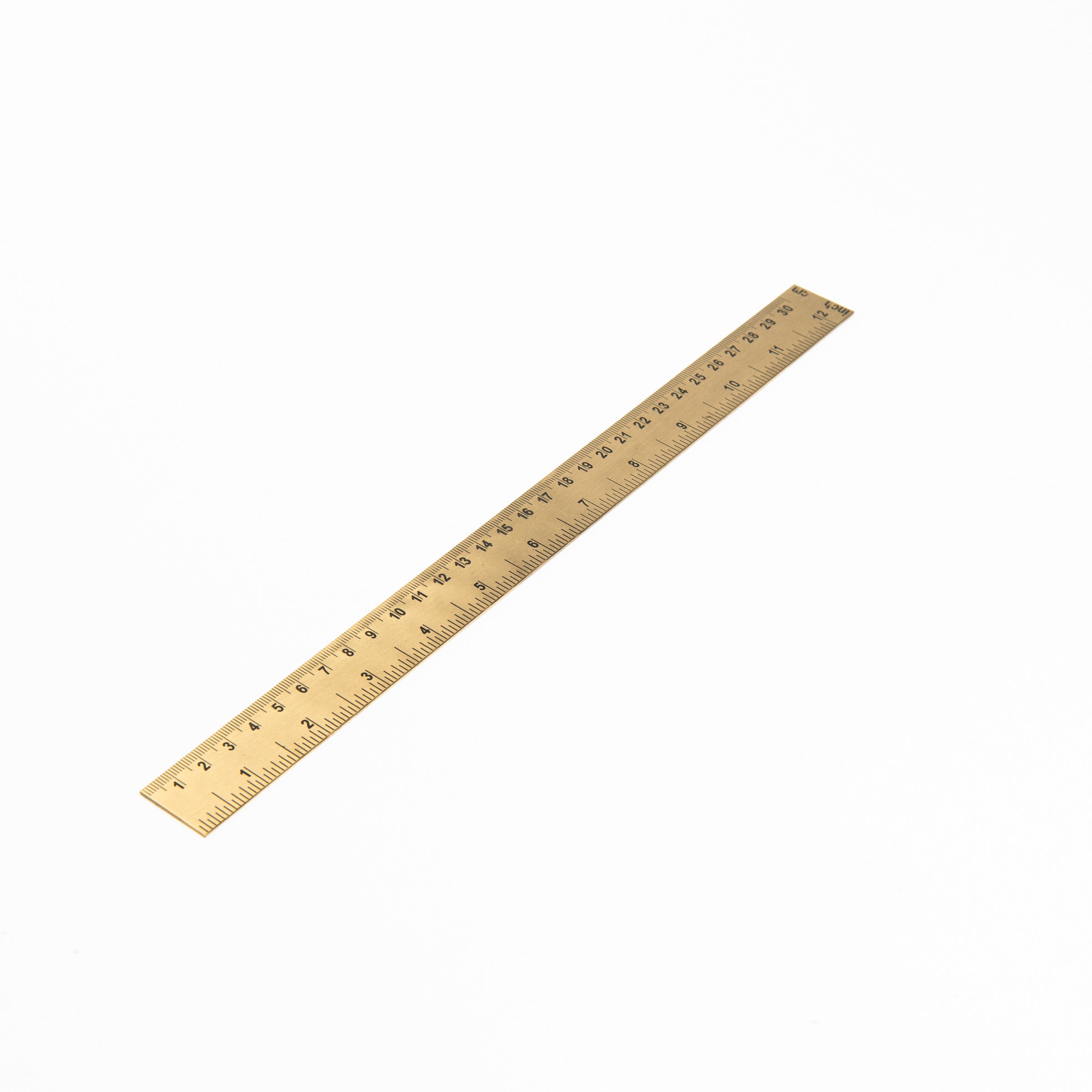 Brass ruler on a white background at Addison West