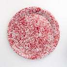 Large round enamelware red serving tray on a white background