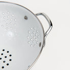 Large White Enamelware Colander on a white background at Addison West