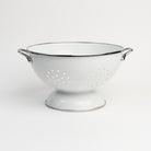 Medium White Enamelware Colander on a white background at Addison West