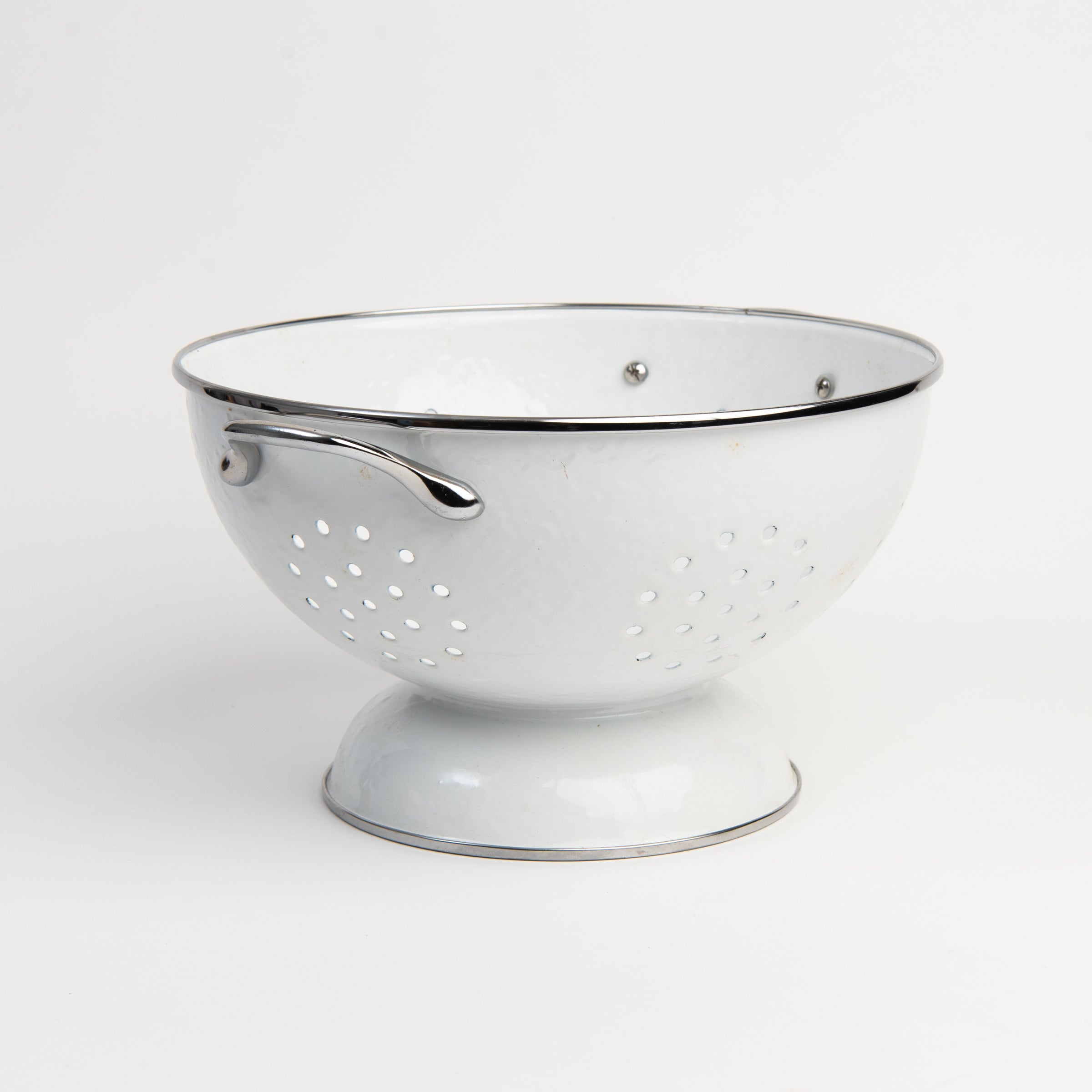 Medium White Enamelware Colander on a white background at Addison West