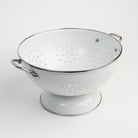 Medium White Enamelware Colander on a white background at Addison West