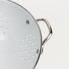 Medium White Enamelware Colander on a white background at Addison West
