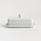 White Porcelain Butter Dish with Knob Handle on a white background at Addison West
