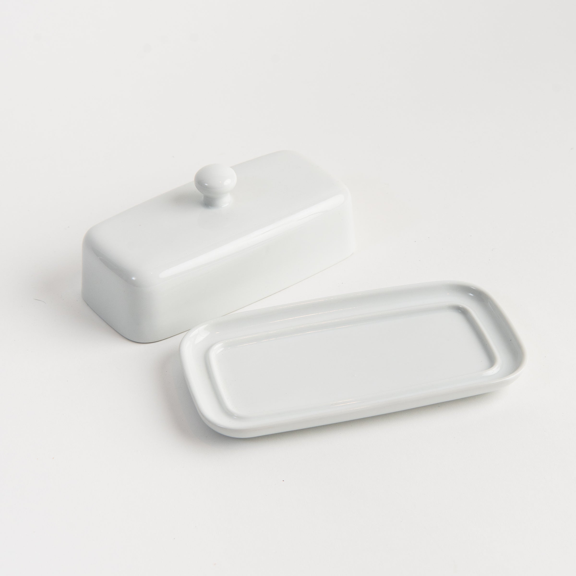 White Porcelain Butter Dish with Knob Handle on a white background at Addison West