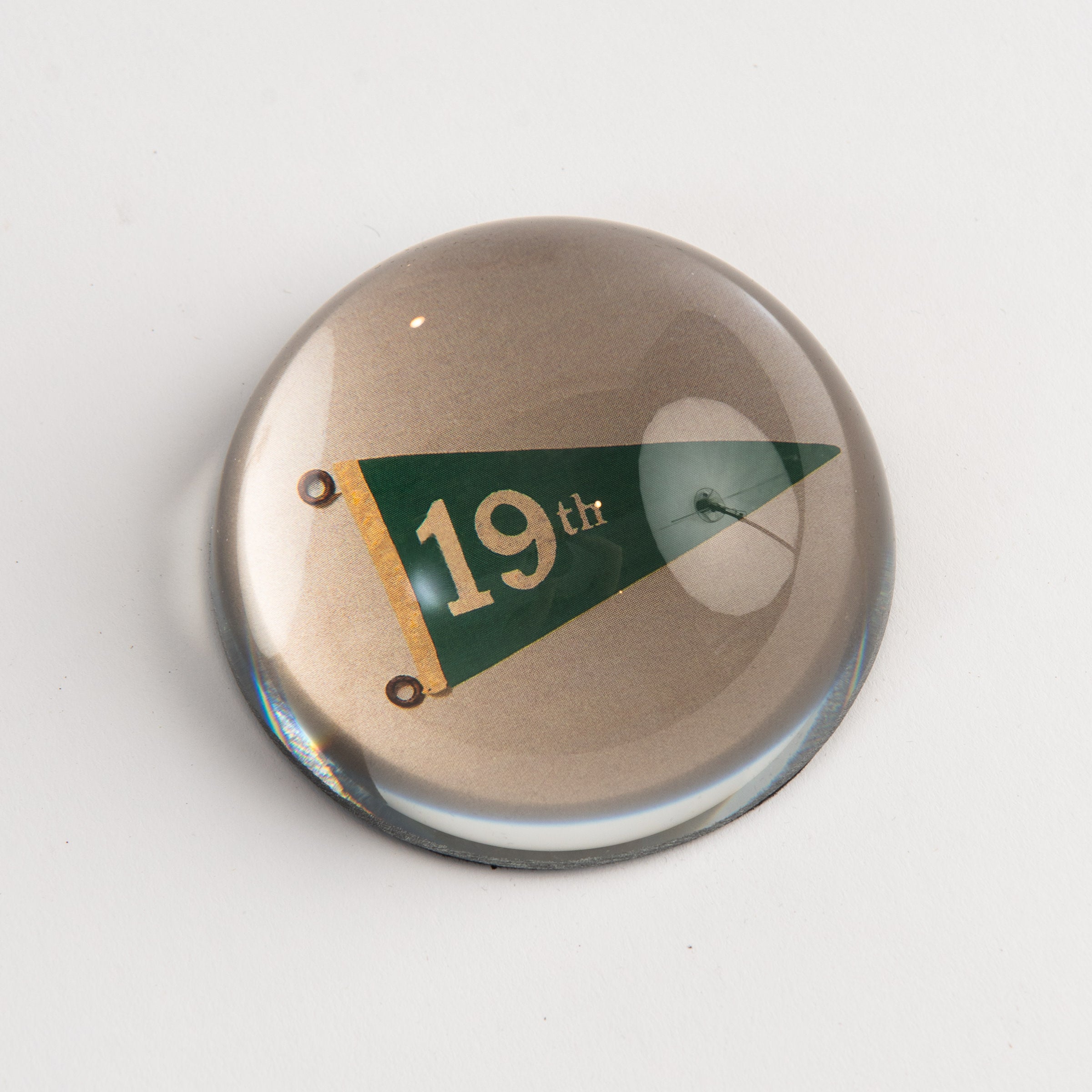 Hole No. 19 Golf Dome Paperweight on a white background at Addison West