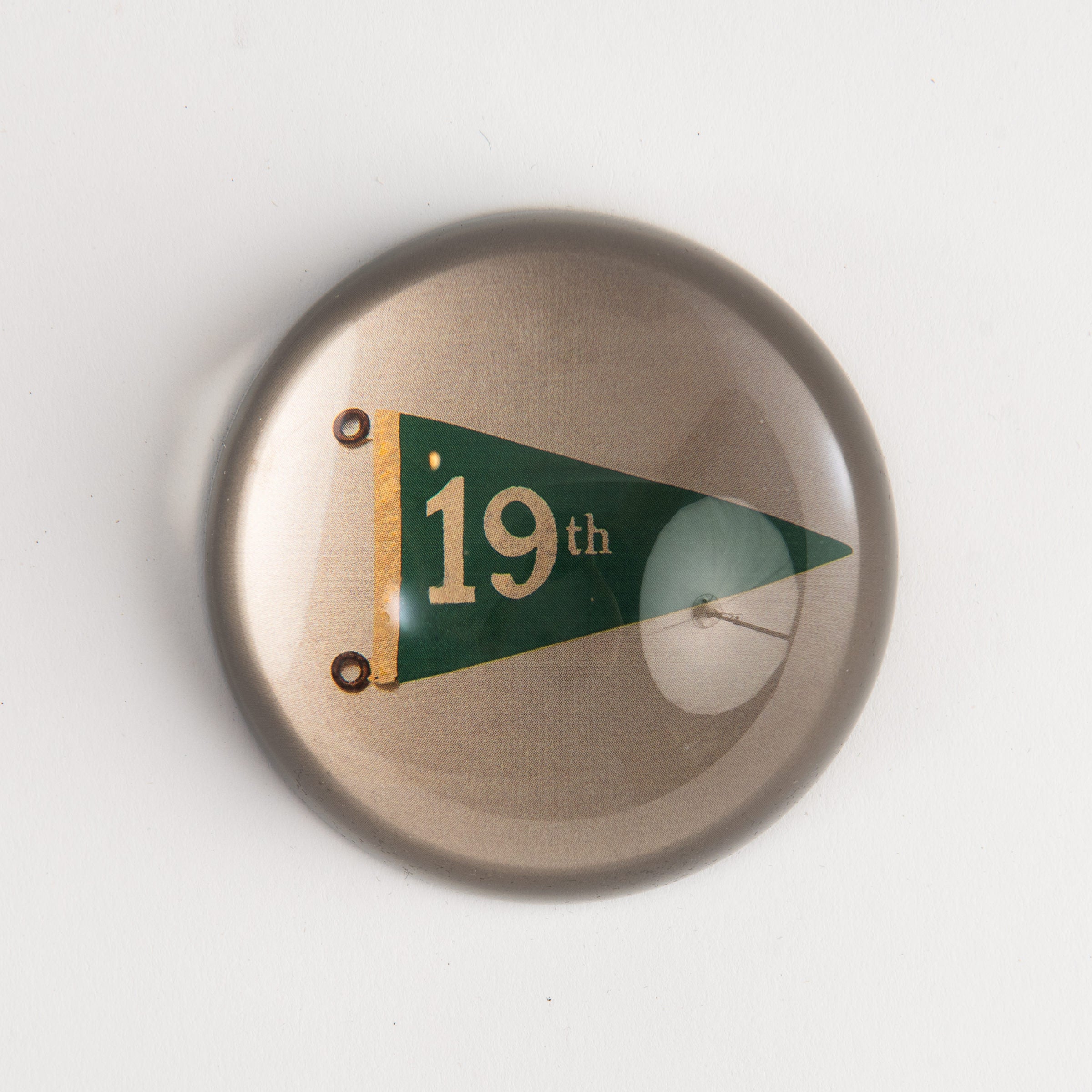 Hole No. 19 Golf Dome Paperweight on a white background at Addison West