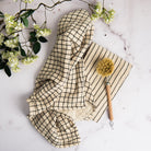 Farmstand Cotton Tea Towel on a marble table at Addison West