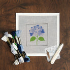 Blue Hydrangea Needlepoint Kit on a table at Addison West