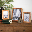 The Classic Wood and Brass Picture Frame on a table at Addison West