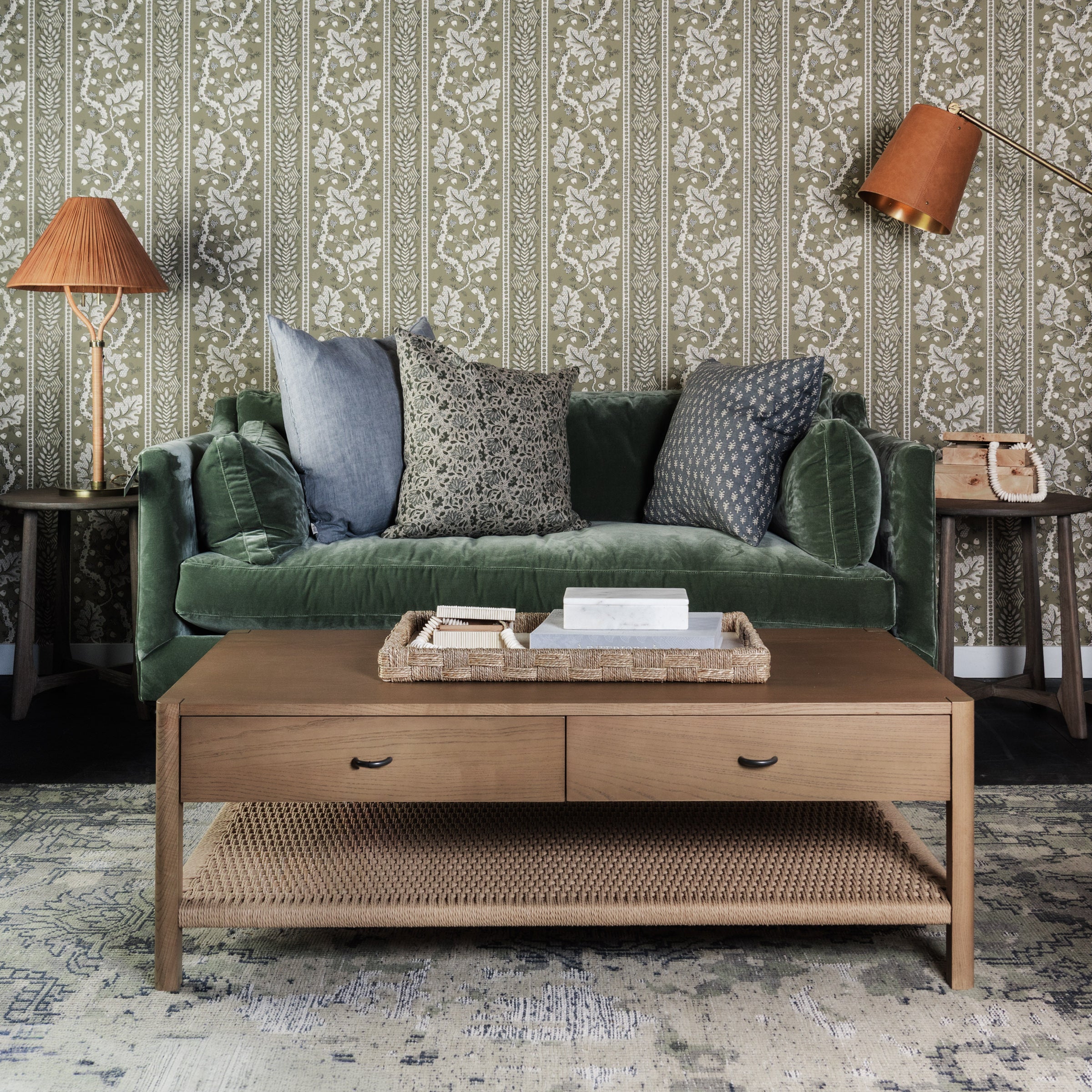 Lina Linen 24" Square Pillow and  in Steel Grey and Astra Blue 22" Square Pillow on a green sofa at Addison West