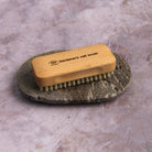 Redecker Gardener's Nail Brush and Travertine Soap Dish on a table at Addison West