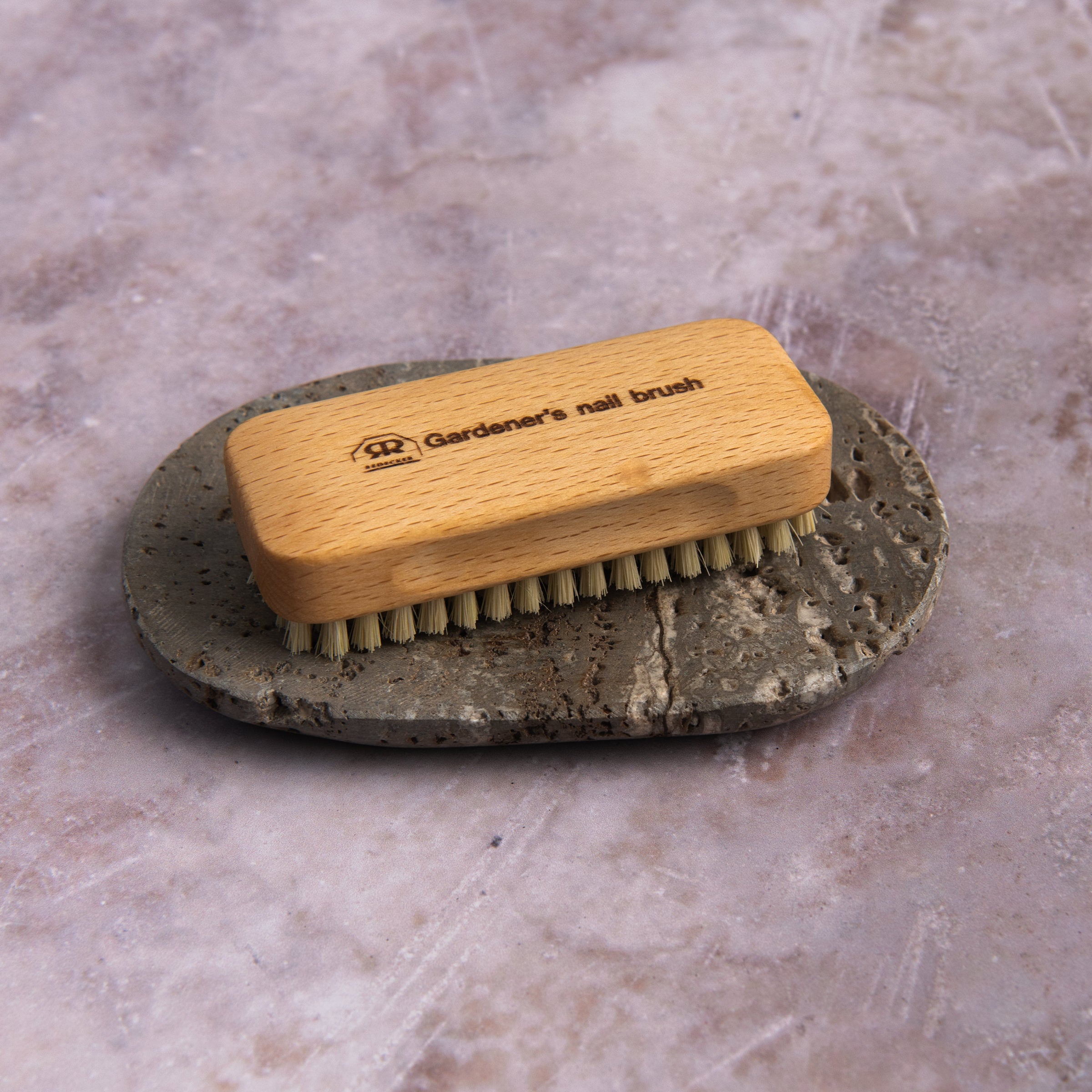 Redecker Gardener's Nail Brush and Travertine Soap Dish on a table at Addison West