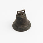 Vintage Bronze Colonial Bell on a white background at Addison West