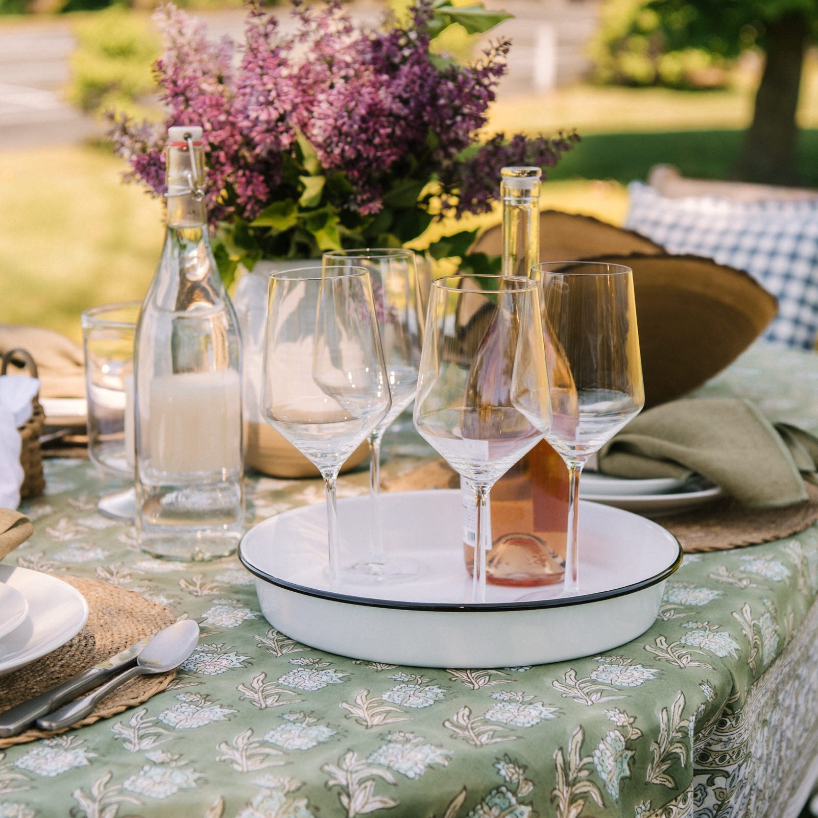 Fortessa Pure Classic Wine Glass, and Vintage Round Enamelware Tray on a table outside at Addison West
