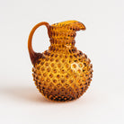 Hobnail Glass Pitcher in Saffron Light on a white background at Addison West