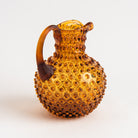 Hobnail Glass Pitcher in Saffron Light on a white background at Addison West