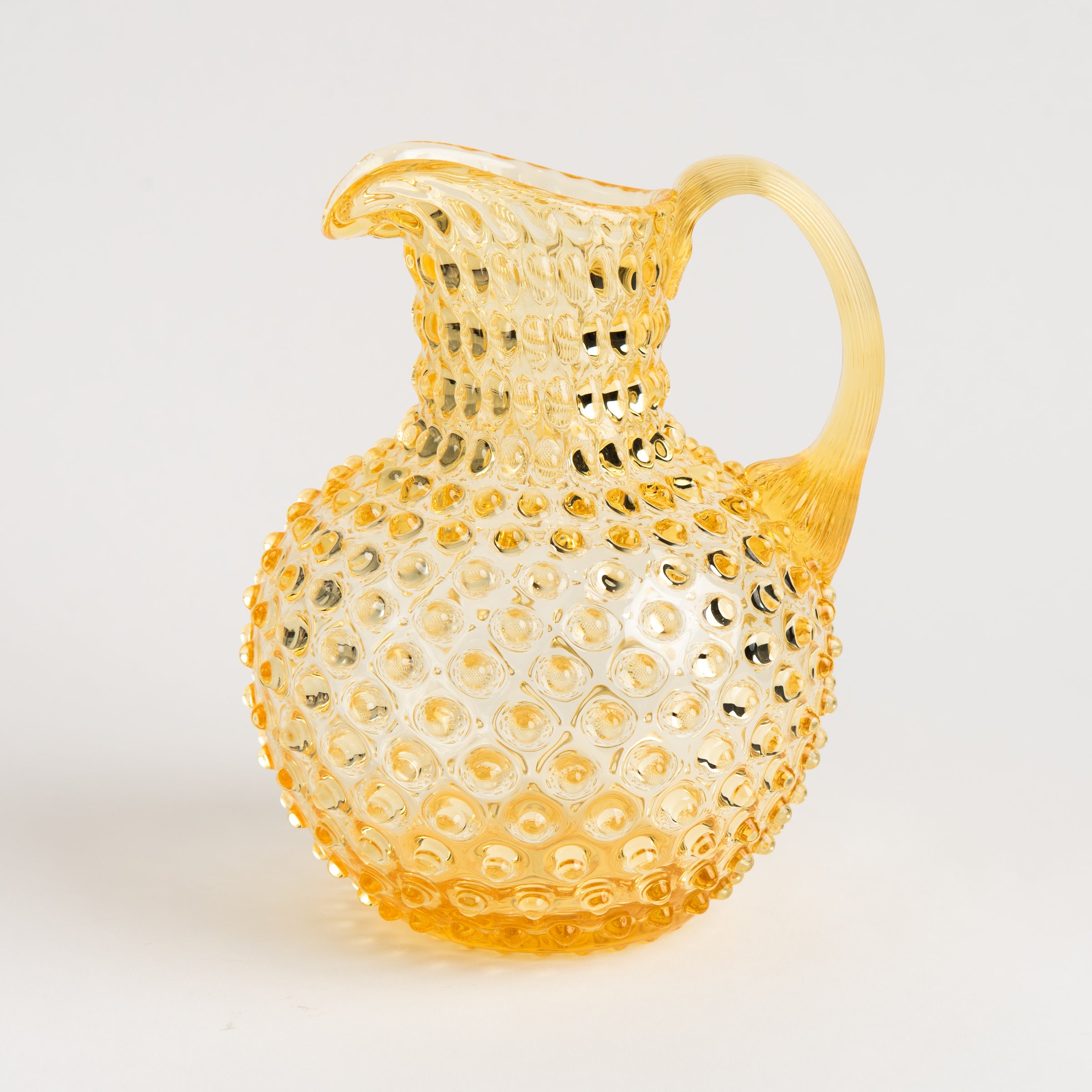 Hobnail Glass Pitcher, Limoncello on a white background at Addison West