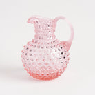 Hobnail Glass Pitcher in Petal Pink on a white background at Addison West