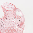 Hobnail Glass Pitcher in Petal Pink on a white background at Addison West