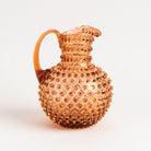 Hobnail Glass Pitcher in Honey Gold on a white background at Addison West